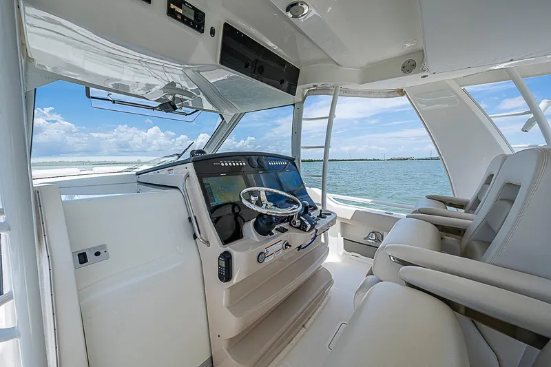 Slide: The Image of 2022 Boston Whaler 420 Outrage helm with modern controls and ocean view. - 5