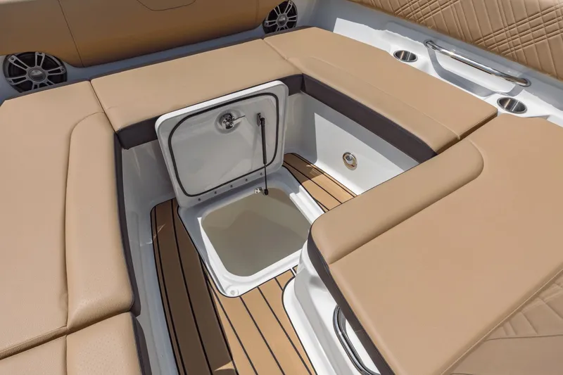 Slide: The Image of The image shows the seating area of a Sea Ray SDX 270 Outboard with an integrated cooler. - 47