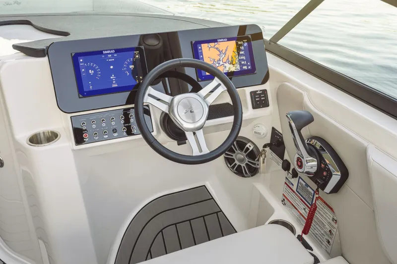 Slide: The Image of The Sea Ray SDX 270 Outboard cockpit features modern instruments and a sleek steering wheel. - 22