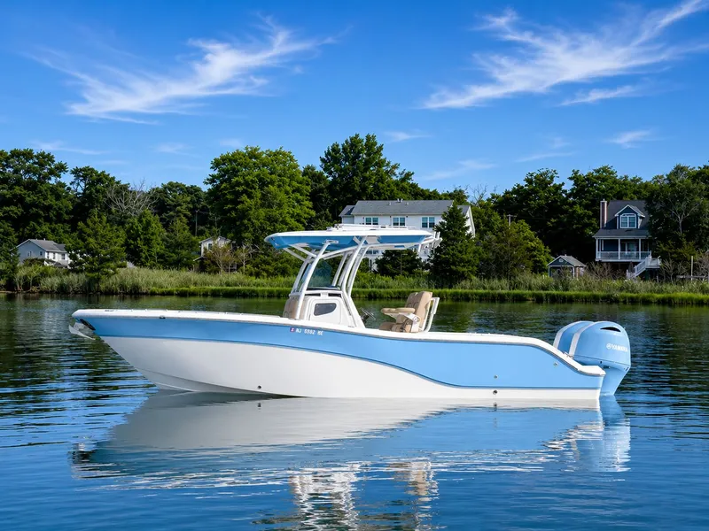 The Image of 2018 Sea Fox 266 Commander on calm water with coastal houses in the background. - 0