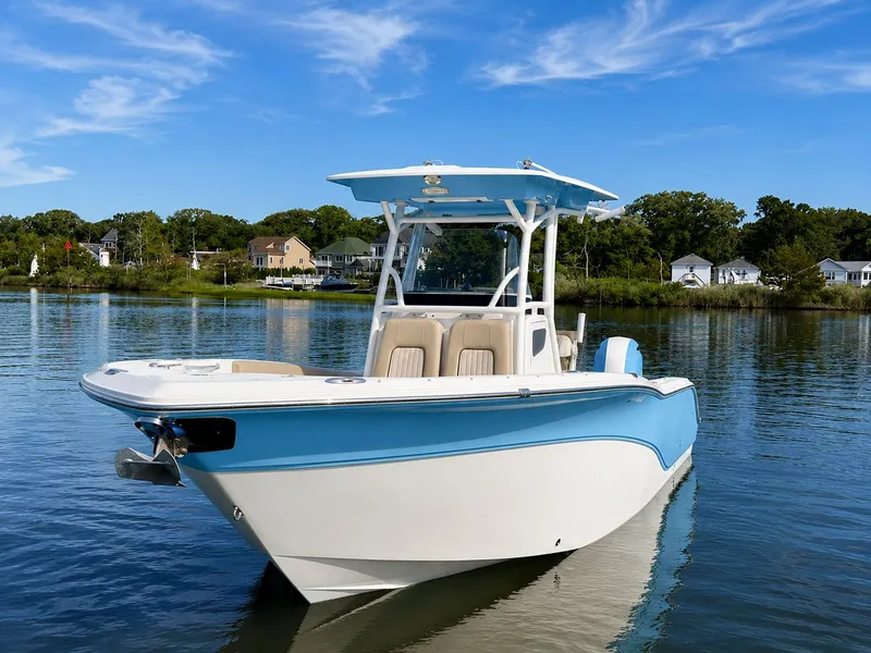 Slide: The Image of A 2018 Sea Fox 266 Commander on calm water with a blue sky in the background. - 2