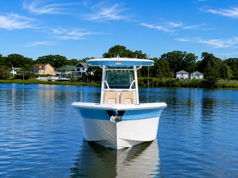Slide: The Image of A 2018 Sea Fox 266 Commander on calm water near a wooded shoreline. - 3
