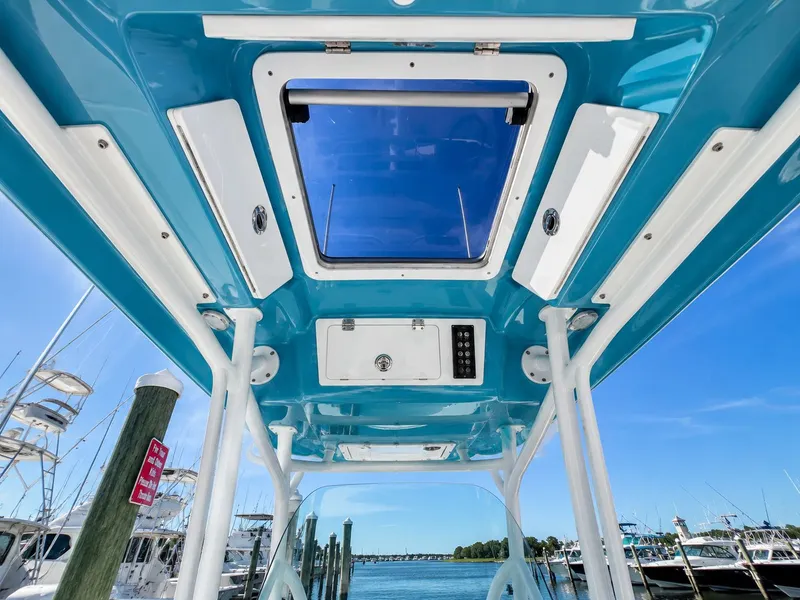 Slide: The Image of View from below of a Sea Fox 266 Commander's blue hardtop with built-in speakers and a glass roof. - 17