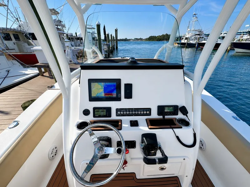 Slide: The Image of The cockpit of a 2018 Sea Fox 266 Commander with modern navigation equipment and a clear view of the harbor. - 6