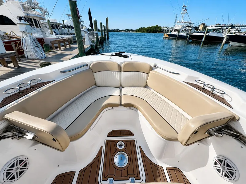 Slide: The Image of The image shows the bow seating area of a 2018 Sea Fox 266 Commander with beige upholstery. - 9