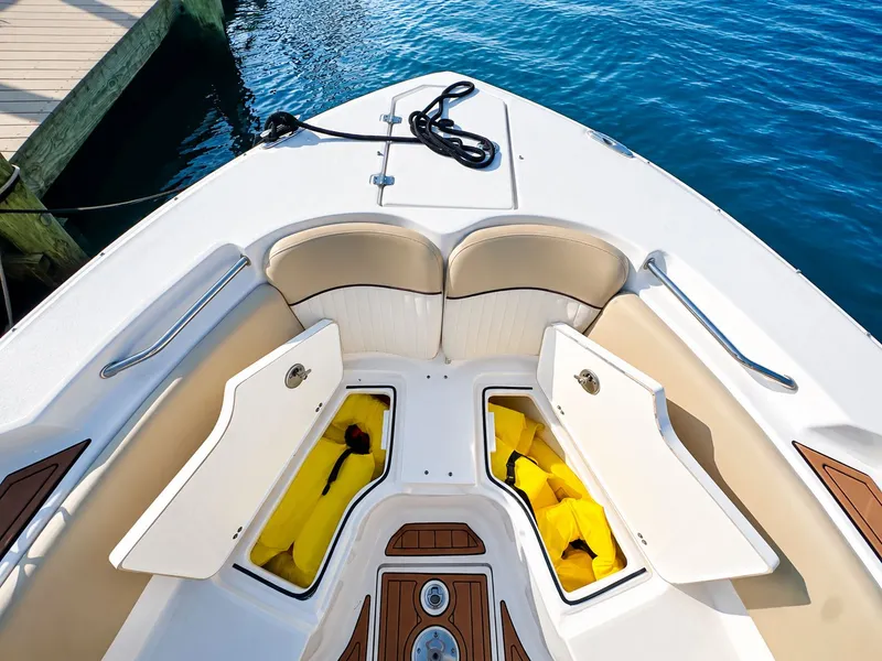 Slide: The Image of The image shows the bow of a 2018 Sea Fox 266 Commander with storage compartments and life jackets. - 12