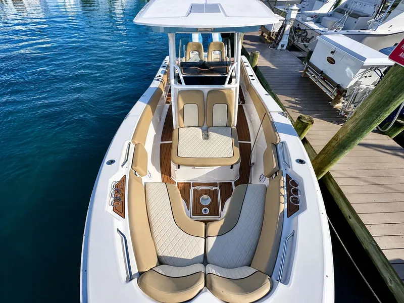 Slide: The Image of A 2018 Sea Fox 266 Commander with sleek seating and wood accents, docked at a pier. - 8