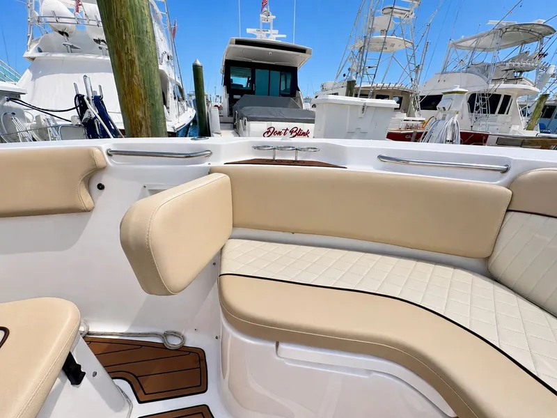 Slide: The Image of The image shows the cockpit of a 2018 Sea Fox 266 Commander with beige upholstery. - 11