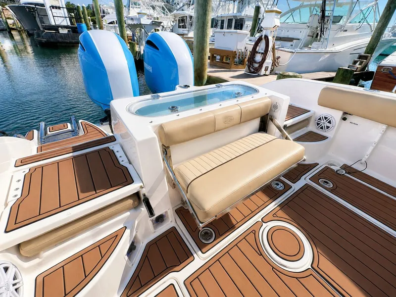 Slide: The Image of The image shows the stern of a 2018 Sea Fox 266 Commander with twin outboard engines and a bench seat. - 25