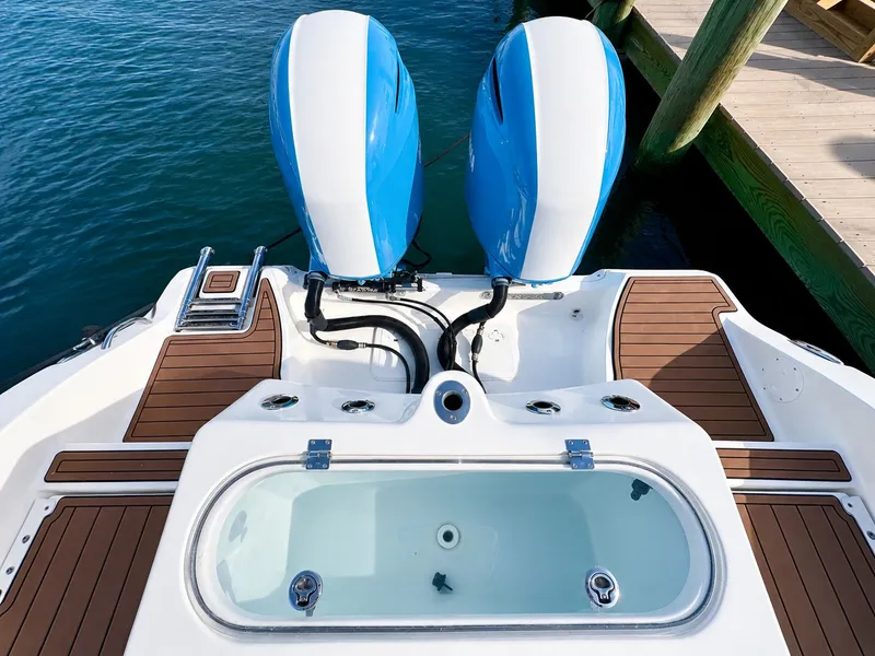 Slide: The Image of The image shows the stern of a 2018 Sea Fox 266 Commander with twin outboard engines and a livewell. - 28