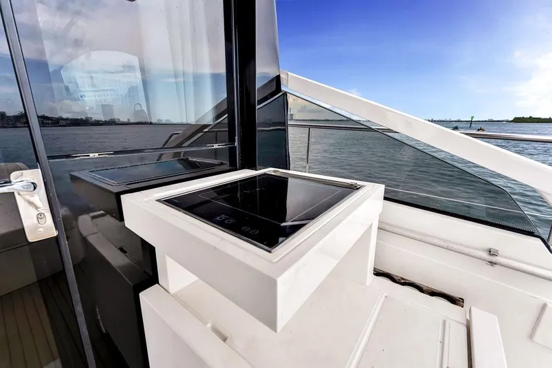 Slide: The Image of Fairline Targa 58 yacht deck with modern outdoor kitchen, overlooking serene waters, 2012 model. - 34