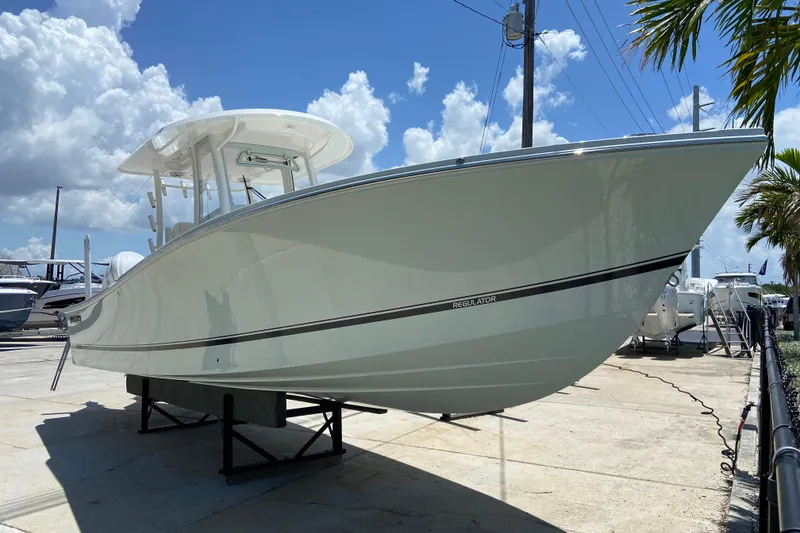 The Image of 2027 Regulator 30XO boat displayed outdoors under a clear blue sky. - 0