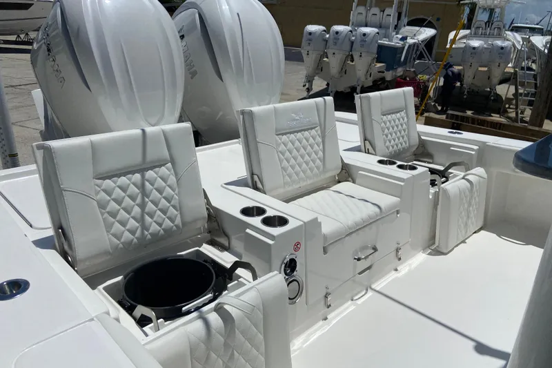 Slide: The Image of Luxurious seating on 2027 Regulator 30XO boat with dual engines in a marina setting. - 10
