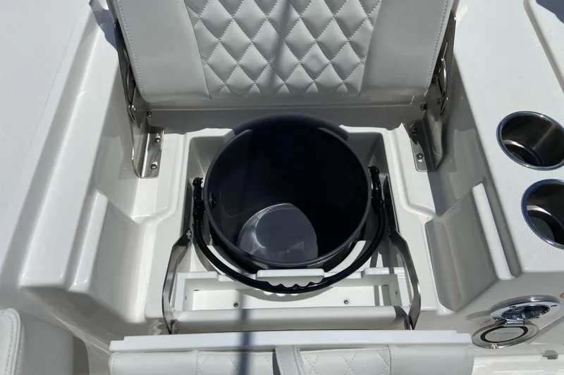 Slide: The Image of 2027 Regulator 30XO boat seat with integrated storage and cup holders. - 11