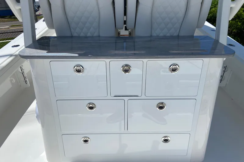 Slide: The Image of 2027 Regulator 30XO boat interior with sleek storage drawers and cushioned seating. - 14