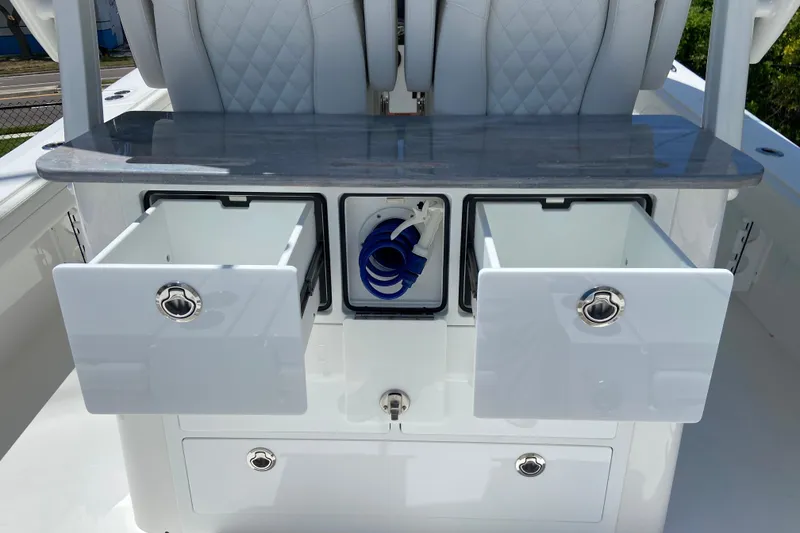 Slide: The Image of 2027 Regulator 30XO boat interior with open storage compartments and seating. - 15