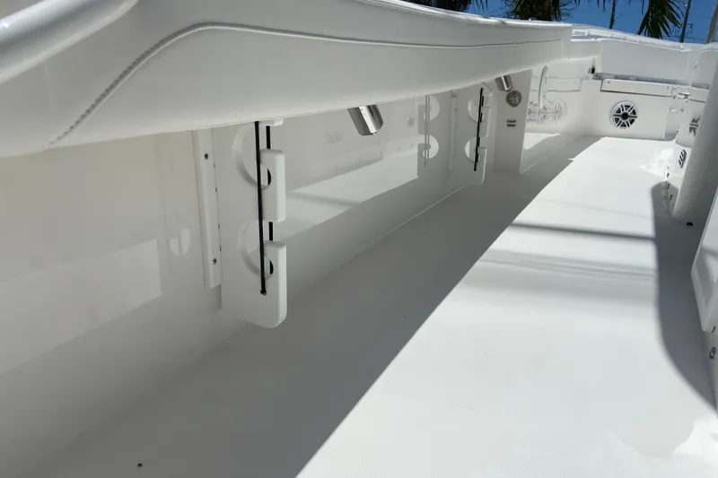 Slide: The Image of 2027 Regulator 30XO boat interior with sleek white design and rod holders. - 19