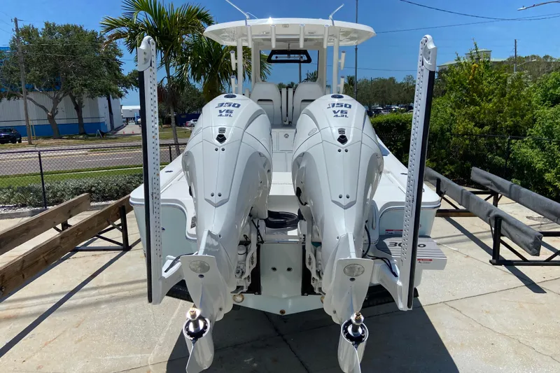 Slide: The Image of 2027 Regulator 30XO boat with dual 350 V8 engines, docked outdoors. - 2