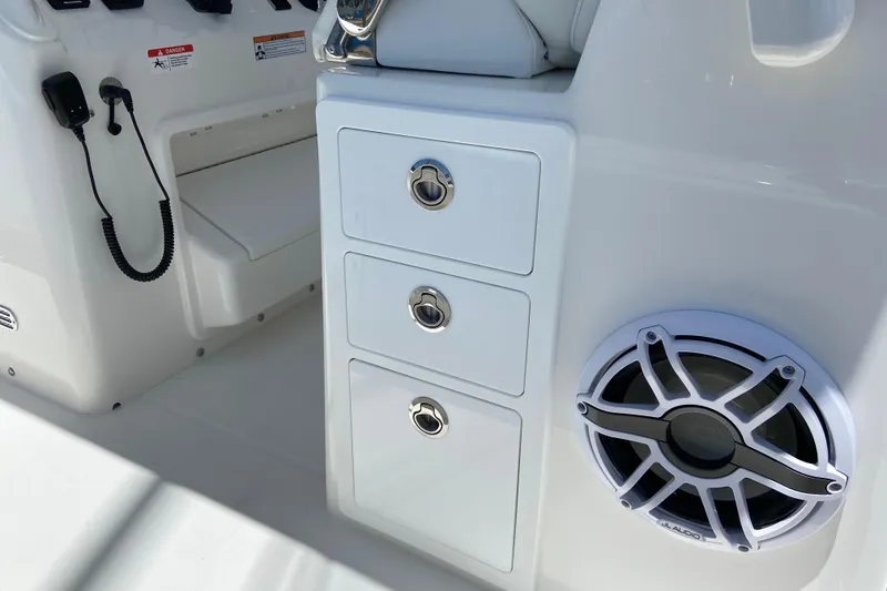 Slide: The Image of 2027 Regulator 30XO boat interior with storage drawers and speaker system. - 20
