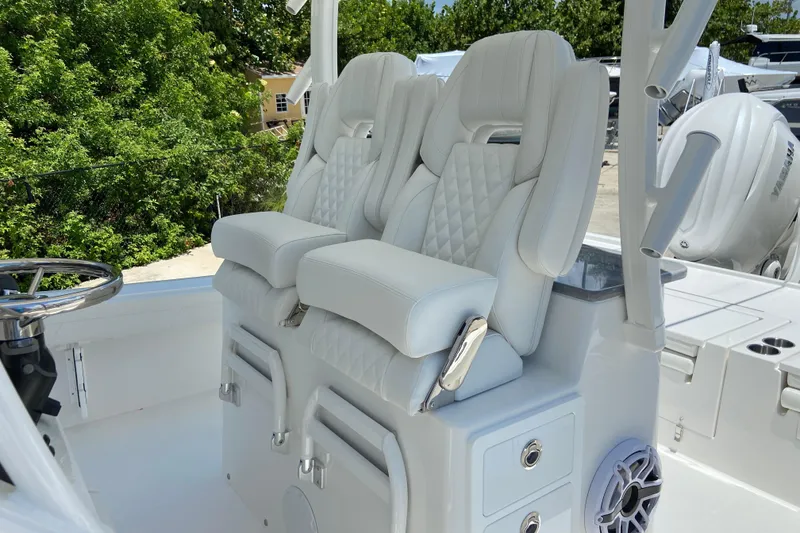 Slide: The Image of Luxury seating on 2027 Regulator 30XO boat, featuring white cushioned captain chairs. - 22