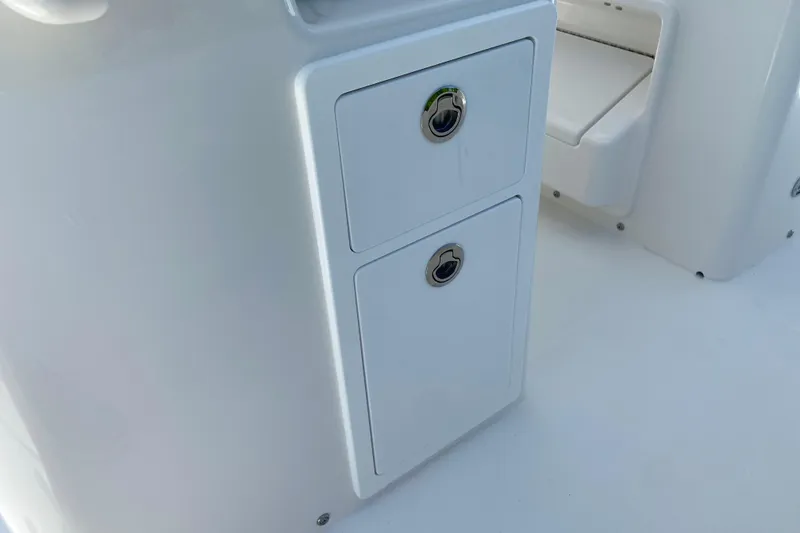 Slide: The Image of Storage compartments on a 2027 Regulator 30XO boat, featuring sleek white design. - 24
