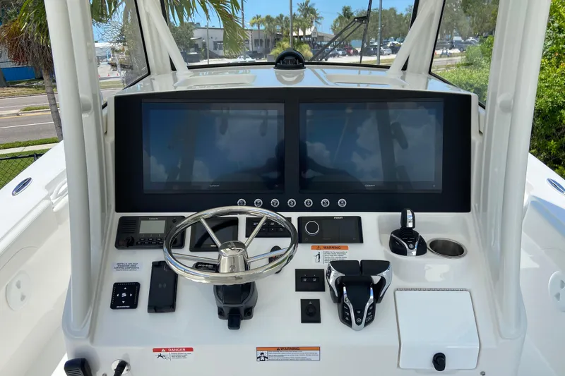 Slide: The Image of Helm of 2027 Regulator 30XO boat with dual displays and modern controls. - 26