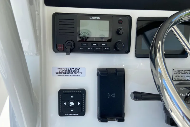 Slide: The Image of Control panel of 2027 Regulator 30XO boat featuring Garmin and Seakeeper systems. - 27