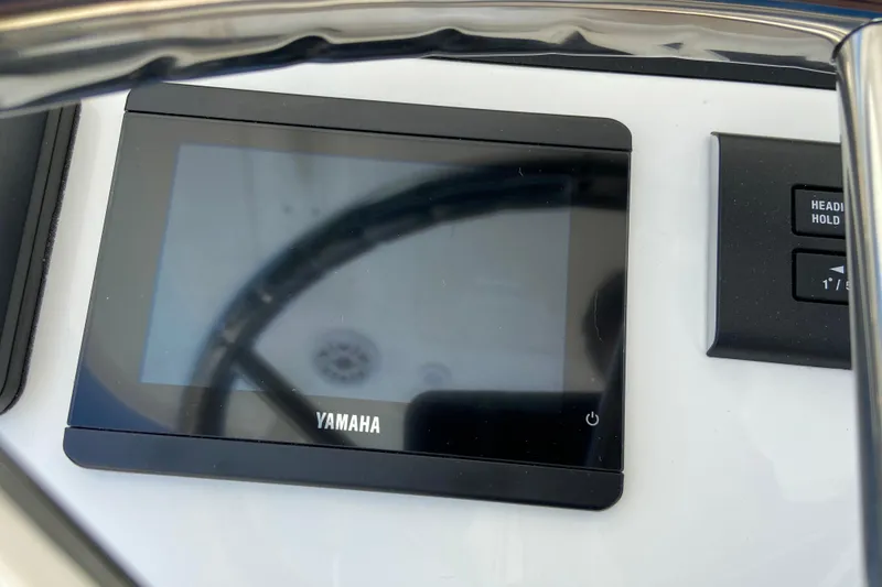 Slide: The Image of Yamaha display on 2027 Regulator 30XO boat dashboard with control buttons. - 29