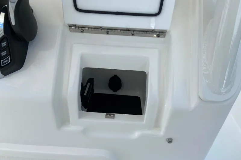 Slide: The Image of Storage compartment on 2027 Regulator 30XO boat console, featuring sleek design and controls. - 34