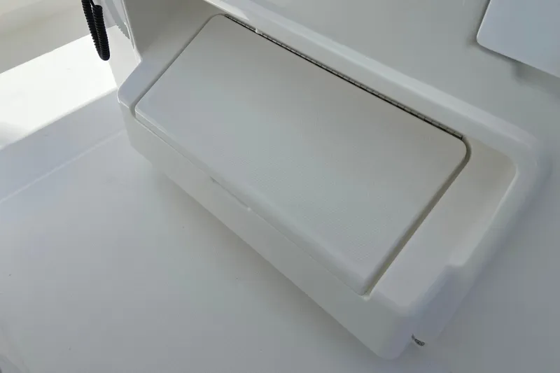 Slide: The Image of 2027 Regulator 30XO boat storage compartment, white interior detail. - 35
