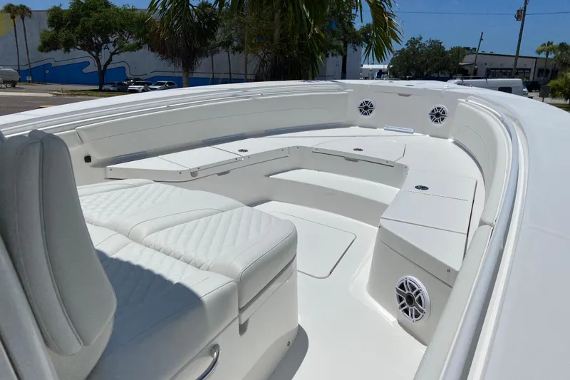 Slide: The Image of 2027 Regulator 30XO boat interior with white seating and speakers, under clear blue sky. - 37