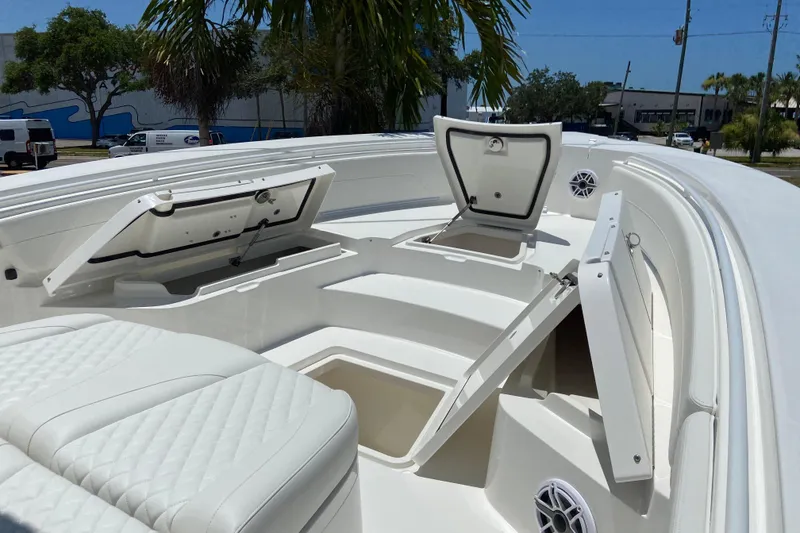 Slide: The Image of 2027 Regulator 30XO boat interior with open storage compartments and cushioned seating. - 38
