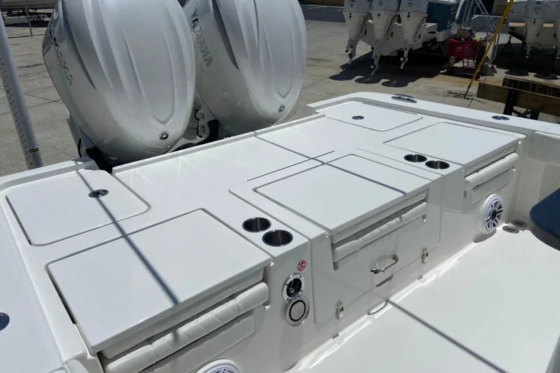 Slide: The Image of 2027 Regulator 30XO boat deck with dual Yamaha outboard engines, featuring storage compartments and cup holders. - 4