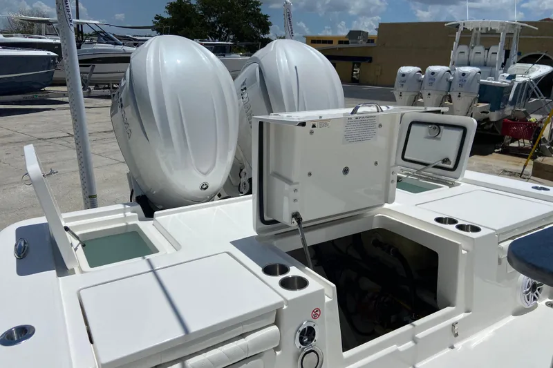 Slide: The Image of 2027 Regulator 30XO boat with dual outboard engines and open storage compartments. - 5
