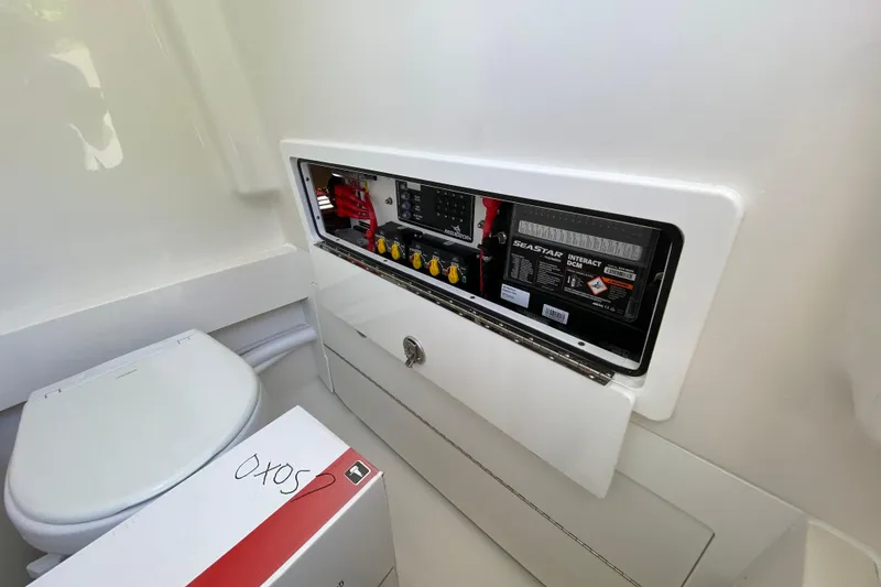 Slide: The Image of Electrical panel and storage area inside a 2027 Regulator 30XO boat cabin. - 52