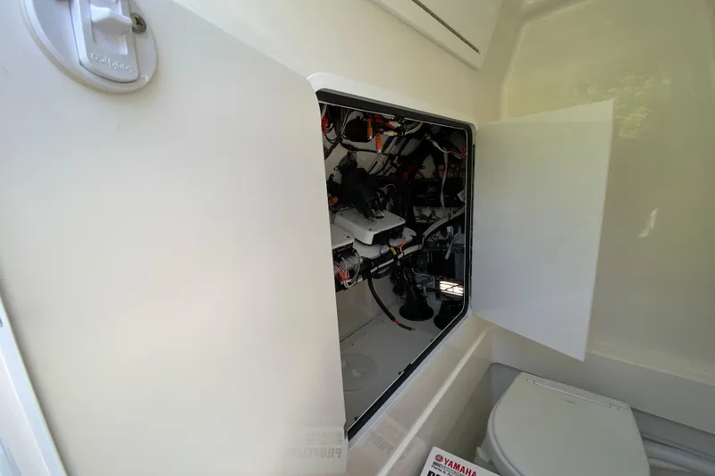 Slide: The Image of Interior view of a 2027 Regulator 30XO boat showing wiring and a toilet. - 53