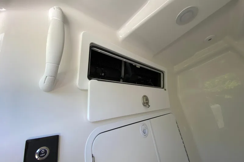 Slide: The Image of Interior storage compartment of 2027 Regulator 30XO boat, featuring sleek design and light control. - 55