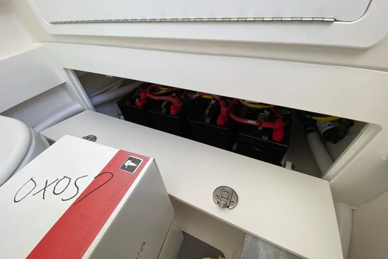 Slide: The Image of Battery compartment of 2027 Regulator 30XO boat, showing multiple batteries and wiring. - 56