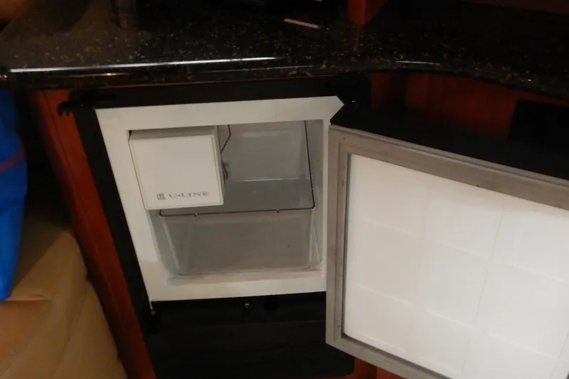 Slide: The Image of Open U-Line refrigerator inside 2008 Meridian 411 Sedan yacht, featuring a compact design. - 25