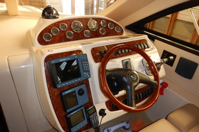 Slide: The Image of 2008 Meridian 411 Sedan helm with wood accents and navigation instruments. - 19