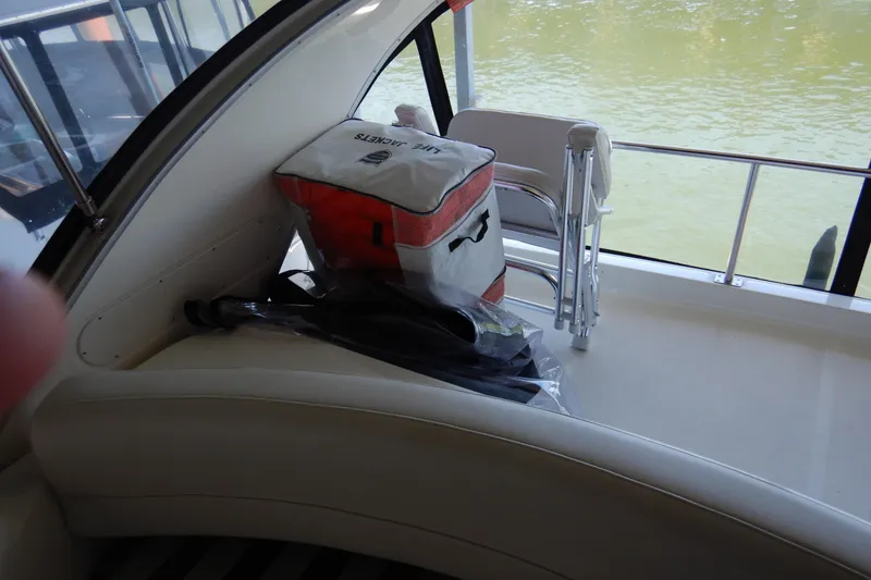 Slide: The Image of 2008 Meridian 411 Sedan boat interior with life jackets and folding chair on deck. - 62