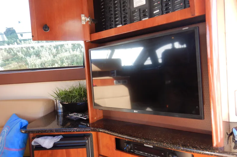 Slide: The Image of 2008 Meridian 411 Sedan interior with TV, control panel, and countertop decor. - 58
