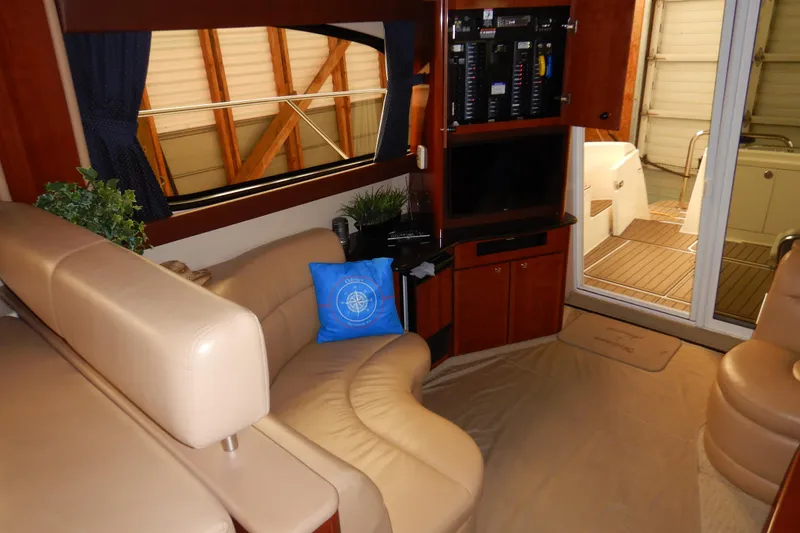 Slide: The Image of Interior of 2008 Meridian 411 Sedan yacht with beige seating and entertainment center. - 11