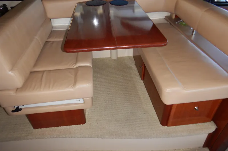 Slide: The Image of Luxurious seating area in a 2008 Meridian 411 Sedan yacht with wooden table and beige upholstery. - 18