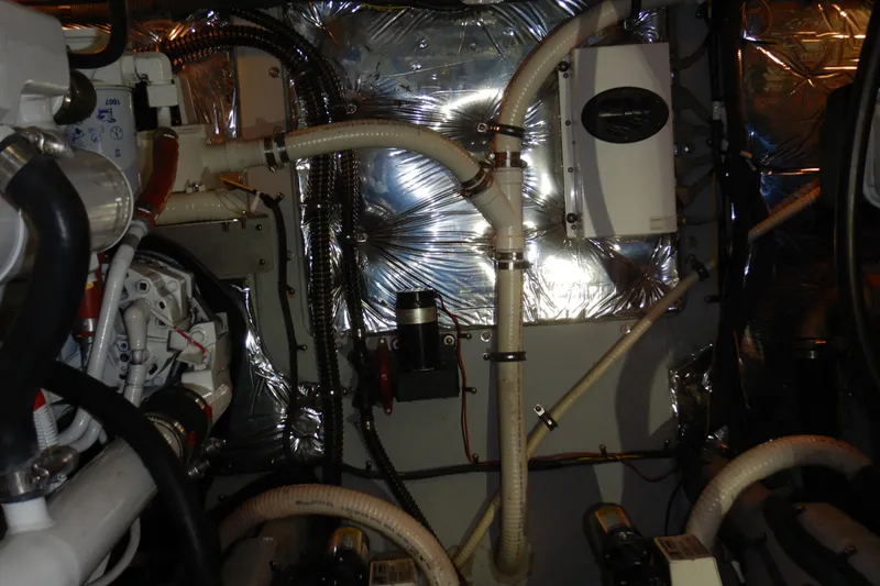 Slide: The Image of Engine room of a 2008 Meridian 411 Sedan with visible pipes and insulation. - 50