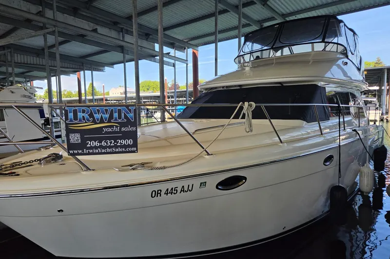Slide: The Image of 2008 Meridian 411 Sedan yacht docked, featuring Irwin Yacht Sales sign. - 2