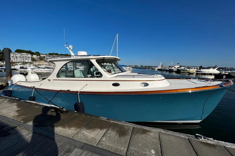 The Image of 2022 Hinckley 35 boat docked at marina under clear blue sky. - 0