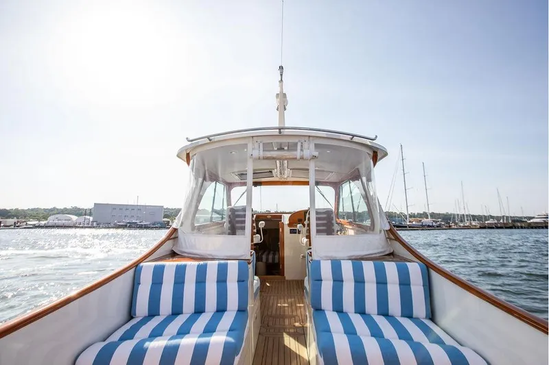 Slide: The Image of Hinckley 35 yacht, 2022 model, with striped seating, cruising on a sunny day. - 2