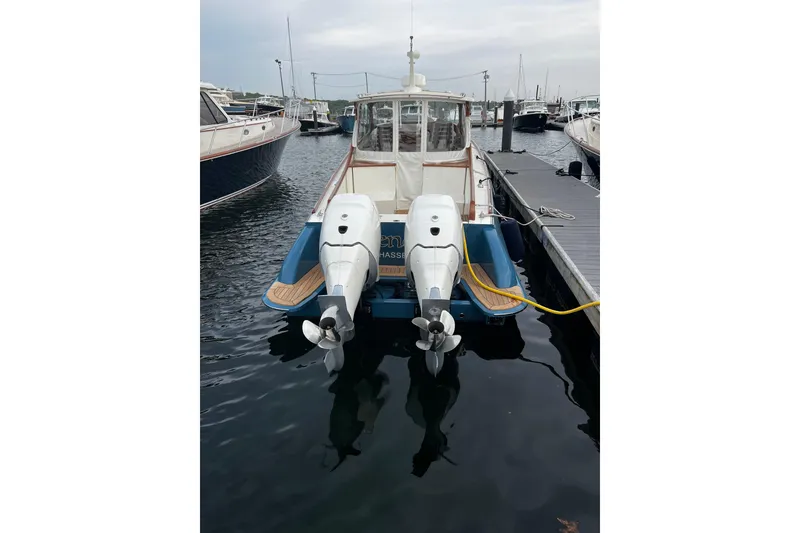 Slide: The Image of Hinckley 35 boat, 2022 model, docked with dual outboard motors, calm marina setting. - 3