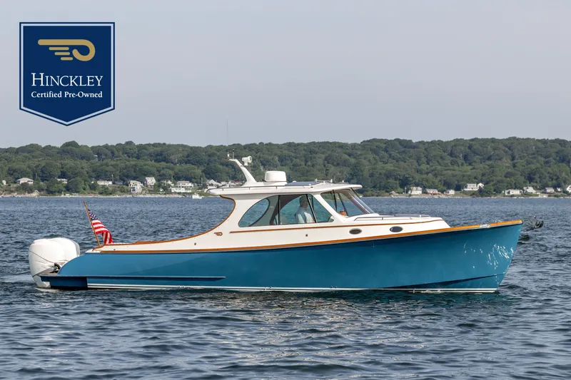 The Image of Hinckley 35, 2022 model, on calm water with a wooded shoreline in the background. - 0